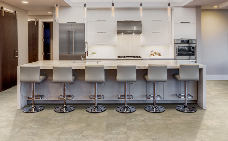 grey toned flooring with whit backsplash in kitchen